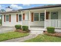 Close-up of a charming front porch featuring a white railing and wooden shutters at 46 Forkwood Cir, Hiram, GA 30141