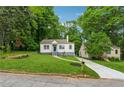 View of the home's front yard surrounded by mature trees, complementing its serene setting at 2590 Eastwood Dr, Decatur, GA 30032
