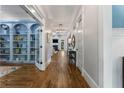 Elegant hallway with hardwood floors, white trim, and a view of the living room with a fireplace at 3253 Cates Ne Ave, Brookhaven, GA 30319