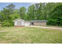 Lovely ranch-style home featuring stone accents, an attached garage, and a well-manicured lawn at 3349 Old Atlanta Rd, Suwanee, GA 30024
