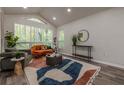 Bright living room features large windows, vaulted ceilings, hardwood floors, and stylish furnishings at 3349 Old Atlanta Rd, Suwanee, GA 30024