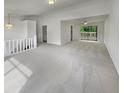Spacious, light-filled living room with plush carpeting and a sliding glass door to the outdoor deck offering plenty of natural light at 6735 Smoke Ridge Dr, Atlanta, GA 30349