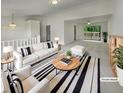 Bright living room with modern decor, plush seating, and sliding glass doors to an outdoor deck, creating an inviting space at 6735 Smoke Ridge Dr, Atlanta, GA 30349