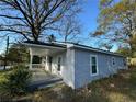 Exterior side view of a freshly painted gray home with a cozy covered porch at 753 2Nd St, Stone Mountain, GA 30083