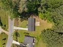 Aerial view of a home featuring a dark roof, a long driveway and mature trees at 2340 Cresta Dr, Decatur, GA 30032