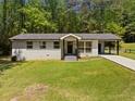 Charming single-story home with a well-maintained lawn, a carport, and a welcoming entrance at 2340 Cresta Dr, Decatur, GA 30032