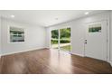 An empty living room with lots of light, beautiful hardwood floors, and freshly painted walls at 2340 Cresta Dr, Decatur, GA 30032