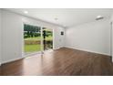 Bright, hardwood-floored living room with a sliding door to the backyard at 2340 Cresta Dr, Decatur, GA 30032