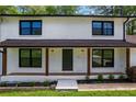 Close-up of a freshly painted home's front door with a well-manicured, landscaped front yard at 3717 Birchbriar Ct, Decatur, GA 30034
