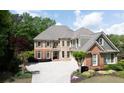 Charming two-story home with a brick and stone facade, manicured landscaping, and a spacious driveway at 4231 Shamans Dr, Marietta, GA 30062