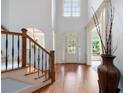 Grand foyer with soaring ceilings, hardwood floors, and a staircase with iron railings at 4231 Shamans Dr, Marietta, GA 30062