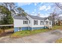 Charming single-story home featuring a driveway, front porch, and light-colored siding at 1496 S Hairston Rd, Stone Mountain, GA 30088