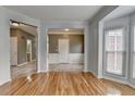 Living room featuring gleaming hardwood floors with a view to the entry way and dining area at 2455 Kirkstone Dr, Buford, GA 30519