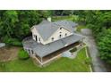 Areal view of the house showing the wrap-around porch, deck, and well-maintained yard and landscaping at 3884 Vic Ar Ct, Peachtree Corners, GA 30360