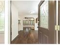 Open entryway with hardwood floors and views into the living space with decorative arches and a ceiling fan at 3884 Vic Ar Ct, Peachtree Corners, GA 30360
