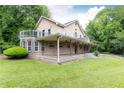 Exterior view of a two-story house with a wrap-around porch and upper deck overlooking a well-manicured lawn at 3884 Vic Ar Ct, Peachtree Corners, GA 30360