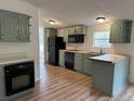 Galley kitchen with butcher block countertops, stainless appliances, and modern flooring at 170 White Rose Ln, Temple, GA 30179