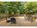 Spacious wooden deck featuring outdoor seating, perfect for entertaining and enjoying the serene backyard at 1875 Fairway Ne Cir, Atlanta, GA 30319