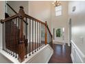 Bright foyer featuring dark hardwood flooring, high ceilings, and a staircase with iron spindles at 2022 Boxwood Ln, Canton, GA 30114