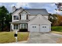 Inviting two-story home featuring stone details and a charming front yard at 5635 Cedar Pass, Fairburn, GA 30213