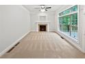 Bright living room featuring fireplace and large window, ready for your personal touch at 7155 Homestead Rd, Rex, GA 30273