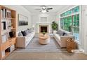 Bright staged living room featuring fireplace, large window, two couches, and area rug at 7155 Homestead Rd, Rex, GA 30273