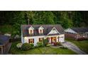 Aerial view of a charming white brick home featuring dormer windows and a well-manicured front yard at 917 Gaylemont Cir, Decatur, GA 30033