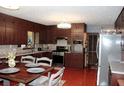 Traditional kitchen with dark cabinets and stainless steel appliances at 255 Deer Run Rd, Ellenwood, GA 30294