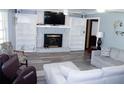 Comfortable living room featuring a cozy fireplace and modern gray flooring at 255 Deer Run Rd, Ellenwood, GA 30294