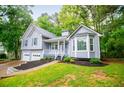 Charming gray two-story home with blue shutters, two-car garage, and well-maintained landscaping at 4822 Westbourne Dr, Powder Springs, GA 30127