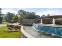 Stone community entrance with fountain and landscaping welcomes you home at 339 Elgin Dr, Lawrenceville, GA 30045