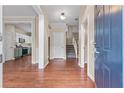 Bright foyer with hardwood floors, staircase, and access to the kitchen at 216 Diamond Valley Pass, Canton, GA 30114