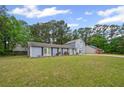 Inviting single-story home with expansive lawn, mature trees, and classic curb appeal at 3999 Wabash Ln, Ellenwood, GA 30294