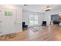 Open living area with hardwood floors, modern lighting, and decorative blue chairs at 3999 Wabash Ln, Ellenwood, GA 30294