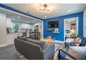 Bright living room with blue accent wall, modern furnishings, and an open view to the kitchen and bedroom at 831 Catherine St, Forest Park, GA 30297