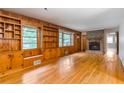 Spacious living room with hardwood floors, built-in bookshelves, and a brick fireplace at 2783 Mount Olive Dr, Decatur, GA 30033