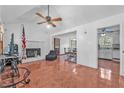 Spacious living room features tile floors, a ceiling fan, and a cozy fireplace at 488 Russell Rd, Lawrenceville, GA 30043