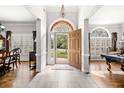 Inviting foyer with tile flooring, an arched doorway, and views of the living spaces beyond at 674 Owl Creek Ct, Powder Springs, GA 30127