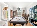 Entertaining game room featuring a billiards table, decorative lighting, and stylish decor at 674 Owl Creek Ct, Powder Springs, GA 30127