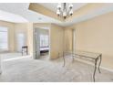 Open living room with natural light and neutral colors, a hanging chandelier, and carpet at 1250 Parkwood Se Cir # 300, Atlanta, GA 30339