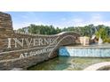 Attractive community entrance with stone signage and water feature at Inverness at Sugarloaf at 349 Elgin Dr, Lawrenceville, GA 30045