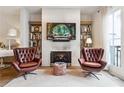 Elegant living room featuring a fireplace, bookshelves, and comfortable seating for relaxation at 3667 Peachtree Ne Rd # 6, Atlanta, GA 30319