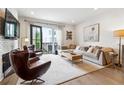 Bright living room features a modern sofa, stylish decor, and access to a private balcony at 3667 Peachtree Ne Rd # 6, Atlanta, GA 30319