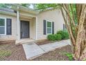 Welcoming front entrance with a dark door and simple landscaping at 7112 Greenway Sw Cv, Covington, GA 30014