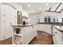 Modern kitchen featuring white cabinets, granite countertops, stainless steel appliances and a center island at 8715 Islesworth Ct, Duluth, GA 30097