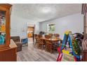 A casual dining room with wood-look floors, a dining table, and a view into the kitchen at 151 Grandma Branch Rd, Grantville, GA 30220
