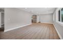 Bright and spacious living room with light gray walls, laminate flooring, and recessed lighting at 1528 Alder Sw Ln, Atlanta, GA 30311