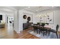 An open dining room features modern decor and lighting with hardwood flooring throughout at 1628 Baytree Dr, Cumming, GA 30040