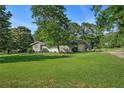 Well-maintained home with a spacious green lawn, attached garage, and a basketball hoop for outdoor activities at 205 Tamea Trl, Covington, GA 30014