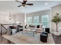 Open living room with hardwood floors, plush seating, and stylish decor at 4905 Greylock Se Walk, Atlanta, GA 30339